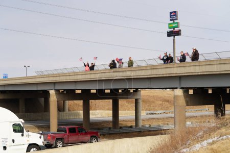 Photo for Oakdale, Wisconsin USA - March 4th, 2022: Pro Americans and pro Trump supporters gathered on I90 and I94 highway overpass waving flags showing support for the Freedom Convoy. - Royalty Free Image