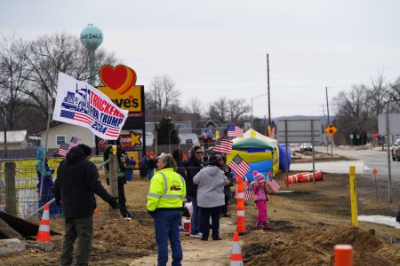 Photo for Oakdale, Wisconsin USA - March 4th, 2022: Pro Americans and pro Trump supporters gathered at Loves Fuel station waving flags and showing support for the Freedom Convoy traveling through Wisconsin. - Royalty Free Image