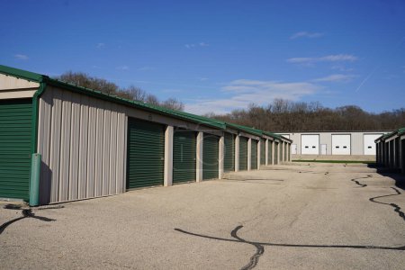 Photo for Green and white storage units being used to hold rental property and belongings. - Royalty Free Image
