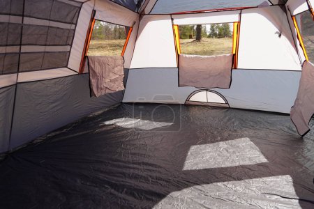 Photo for New Lisbon, Wisconsin USA - May 18th, 2022: Inside of Dark Gray Orange trim Ozark Trail 14 x 10 extra large tent. - Royalty Free Image