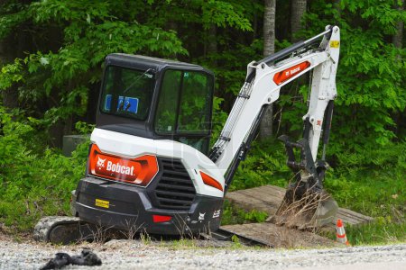 Photo for Tomah, Wisconsin USA - June 10th, 2023: Bobcat E35 compact mini excavator sits on the roadside waiting to be used. - Royalty Free Image