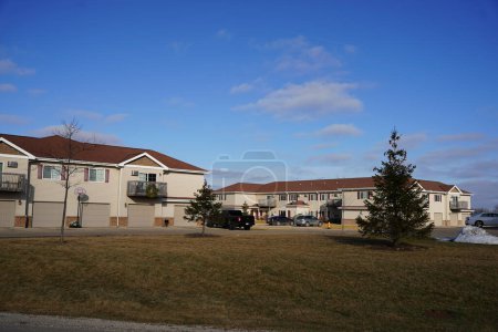 Photo for Fond du Lac, Wisconsin USA - January 15th, 2023: Brown and tan apartment complex buildings holding residents. - Royalty Free Image
