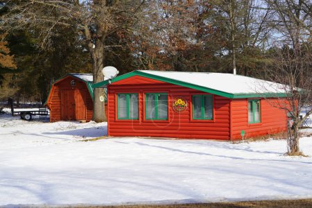 Photo for New Lisbon, Wisconsin USA - January 24th, 2023: Little Red log cabin house sits out in the Winter snow. - Royalty Free Image