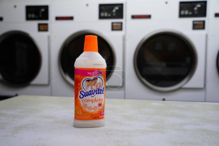 Photo for New Lisbon, Wisconsin USA - February 2nd, 2023: 14.4 fl oz Orange bottle of Suavitel complete Sunshine Bloom fabric conditioner at a laundromat. - Royalty Free Image
