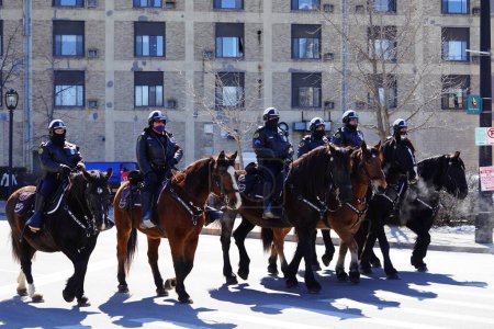 Photo for Milwaukee, Wisconsin USA - March 12th, 2022: Milwaukee Police department officers rode on horses in St. Patrick's Day parade. - Royalty Free Image