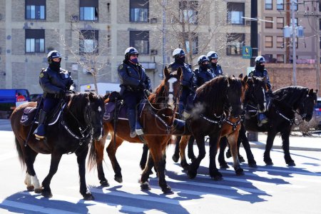 Photo for Milwaukee, Wisconsin USA - March 12th, 2022: Milwaukee Police department officers rode on horses in St. Patrick's Day parade. - Royalty Free Image