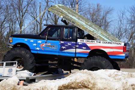 Photo for Montello, Wisconsin USA - March 18th, 2023: Business owner uses a old Ford monster truck with American flag graphics to advertise their business. - Royalty Free Image