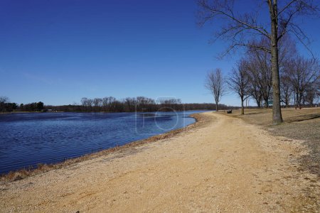 Photo for Dirt walking path along a lake during early spring. - Royalty Free Image
