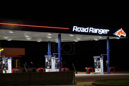 Photo for Road ranger fuel pump station glows during the night. - Royalty Free Image