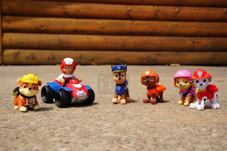 Photo for New Lisbon, Wisconsin USA - May 12th, 2023: Ryder, Chase, Rubble, Skye, Marshall and, Zuma Spin Master Paw Patrol cartoon character figurines sit outside. - Royalty Free Image