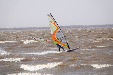 Photo for Fond du Lac, Wisconsin / USA - May 3rd, 2020: Locals from Fond du Lac and out of state members enjoyed windsurfing and kitesurfing out on Winnebago Lake went against safer at home coronavirus pandemic - Royalty Free Image