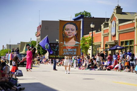 Photo for Sheboygan, Wisconsin USA - July 4th, 2019: Climate environmental activist and greta thunberg supporters marched in freedom pride parade during 4th of july celebration - Royalty Free Image