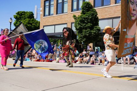 Photo for Sheboygan, Wisconsin USA - July 4th, 2019: Climate environmental activist and greta thunberg supporters marched in freedom pride parade during 4th of july celebration - Royalty Free Image