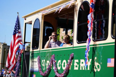Photo for Sheboygan, Wisconsin / USA - July 4th, 2019: Titletown trolley bus travel through 4th of july american freedom pride parade. - Royalty Free Image