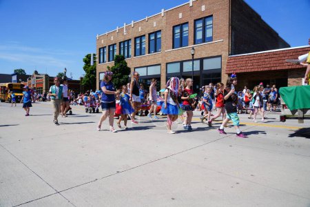 Photo for Sheboygan, Wisconsin USA - July 4th, 2019: Bethlehem lutheran church and school adult and children members dressed up in american freedom pride colors passing out candy to spectators in parade. - Royalty Free Image