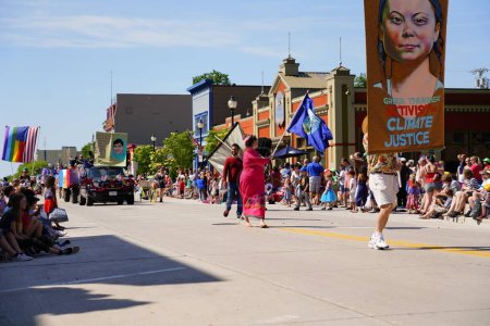 Photo for Sheboygan, Wisconsin USA - July 4th, 2019: Climate environmental activist and Greta Thunberg supporters marched in the freedom pride parade during 4th of july celebration. - Royalty Free Image