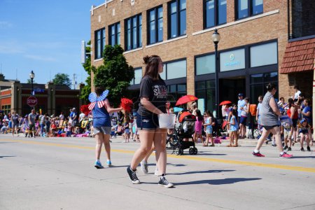 Photo for Sheboygan, Wisconsin USA - July 4th, 2019: Climate environmental activists marched in the freedom pride parade during 4th of july celebration. - Royalty Free Image