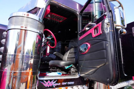 Photo for Waupun, Wisconsin USA - August 11th, 2023: Inside cabin of a Pink and Black semi truck. - Royalty Free Image