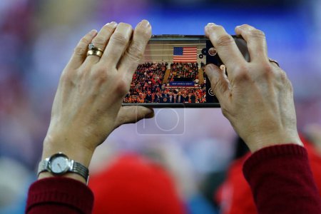 Photo for Milwaukee, Wisconsin / USA - January 14th, 2020: 45th President Donald Trump supporters using their smartphones to capture the Make America Great Again Rally at UW-Milwaukee Panther Arena - Royalty Free Image