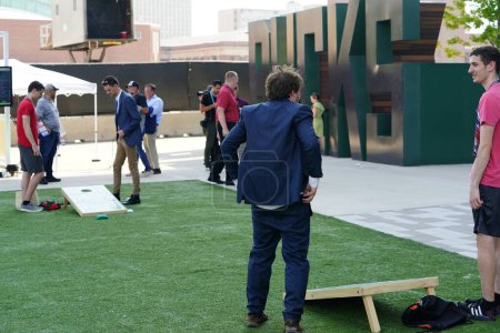Photo for Milwaukee, Wisconsin USA - August 23rd, 2023: While guests waited outside at the Fiserv Forum for the Republican Presidential Debate to begin some played corn hole bean bag toss games. - Royalty Free Image