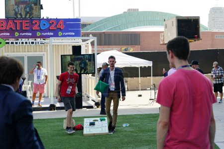 Photo for Milwaukee, Wisconsin USA - August 23rd, 2023: While guests waited outside at the Fiserv Forum for the Republican Presidential Debate to begin some played corn hole bean bag toss games. - Royalty Free Image