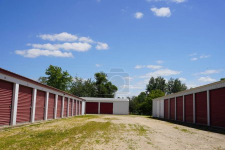 Photo for Mautson, Wisconsin USA - July 10th, 2021: Red storage unit buildings site outside of Mauston, Wisconsin holding owers property. - Royalty Free Image