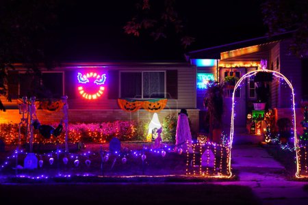 Photo for New Lisbon, Wisconsin USA - October 30th, 2021: Halloween decorations glow up house owner's yard at night. - Royalty Free Image