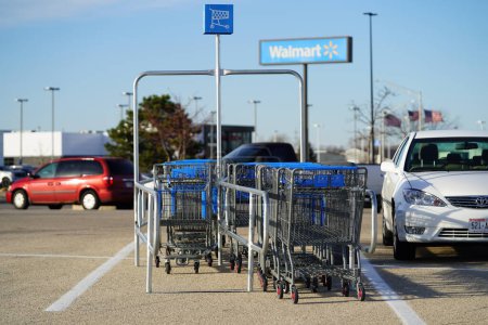Photo for Fond du Lac, Wisconsin USA - November 26th, 2022: Blue and grey shopping carts sitting at a cart corral at Walmart parking lot. - Royalty Free Image
