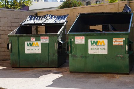 Photo for Neenah, Wisconsin / USA - October 27th, 2019: Waste Management green Garbage dumpster used within the community for people to dump their trash - Royalty Free Image