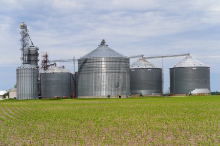 Photo for New Lisbon, Wisconsin USA - April 20th, 2023: Grain silos and grain elevators sit on farmland. - Royalty Free Image