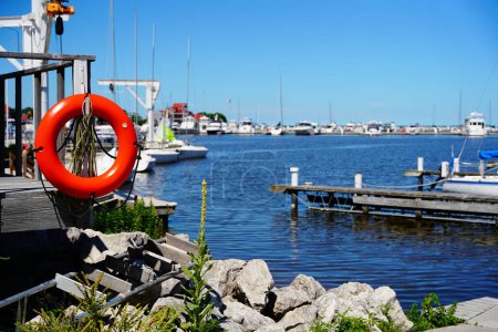 Photo for Sheboygan, Wisconsin / USA - July 18th, 2020: Boats and yachts sit docked at the marina docks on the lake of michigan - Royalty Free Image