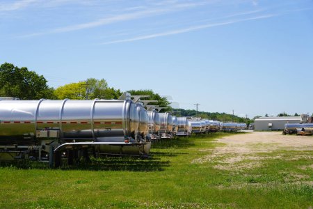 Photo for Mauston, Wisconsin USA - June 4th, 2021: Chemical tank trailers sit outside in the countryside of Mauston. - Royalty Free Image