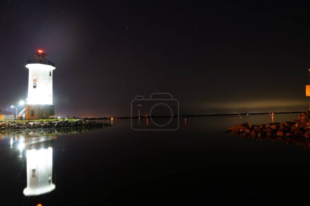 Photo for Night shot of Fond du Lac, Wisconsin Lighthouse off of Lake Winnebago out in Lakeside park during the cold Winter season - Royalty Free Image