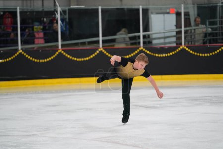 Photo for Mosinee, Wisconsin USA - February 26th, 2021: Young teenage male boy participated in badger state winter games ice skating competition. - Royalty Free Image