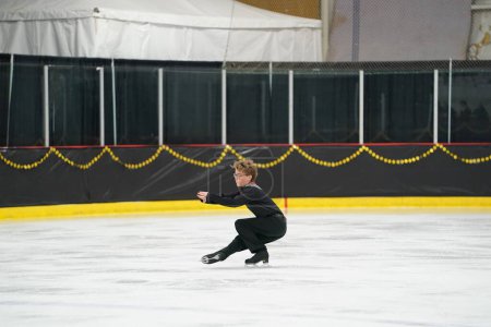 Photo for Mosinee, Wisconsin USA - February 26th, 2021: Young teenage male boy participated in badger state winter games ice skating competition. - Royalty Free Image