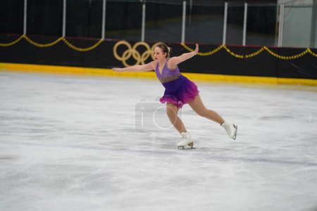 Téléchargez les photos : Mosinee, Wisconsin États-Unis - 26 février 2021 : Femme adulte dans une belle robe violette a participé à la compétition de patinage sur glace des jeux d'hiver de l'État du blaireau - en image libre de droit