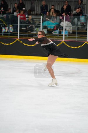 Téléchargez les photos : Mosinee, Wisconsin États-Unis - février 26th, 2021 : Une jeune femme adulte dans une belle robe colorée a participé à la compétition de patinage sur glace des jeux d'hiver de l'État du blaireau - en image libre de droit