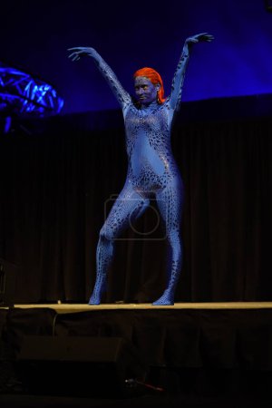 Photo for Milwaukee, Wisconsin USA - February 13th, 2020: Female dressed up in marvel x-men mystique cosplay costume to participate in anime Milwaukee masquerade contest. - Royalty Free Image