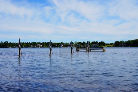 Photo for Landscape view of the waters of Sturgeon Bay, Wisconsin flooding onto the shore line of Sturgeon Bay. - Royalty Free Image