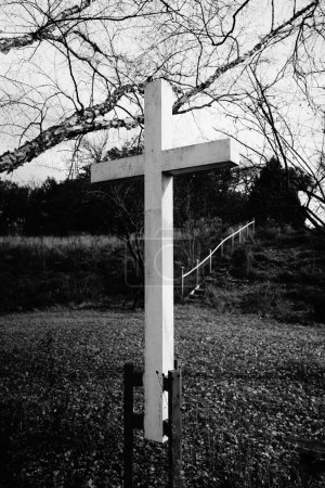 Photo for White wooden Christian cross stands on sacred area outside of Fond du Lac, Wisconsin county - Royalty Free Image