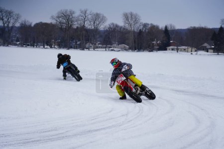 Photo for Hortonville, Wisconsin / USA - January 26th, 2019: Many riders on dirt bikes were having fun riding around on snow covered frozen iced lake - Royalty Free Image