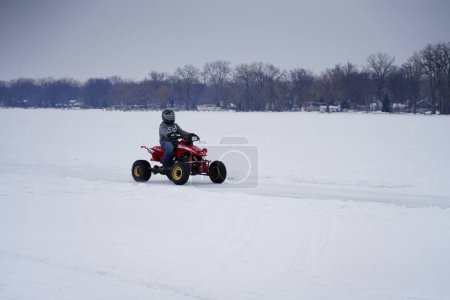 Photo for Hortonville, Wisconsin / USA - January 26th, 2019: Many riders on Quad-bikes and ATVs were having fun riding around on snow covered frozen iced lake - Royalty Free Image