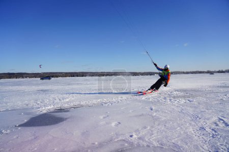 Photo for Fond du Lac, Wisconsin USA - February 8th, 2019: Locals from the fond du lac community enjoyed winter ice kite windsurfing on the frozen lake of winnebago. - Royalty Free Image