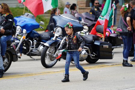 Photo for Milwaukee, Wisconsin USA - September 16th, 2023: Latino American families gathered along the streets to watch and spectate the Mexican Independence Day Parade. - Royalty Free Image
