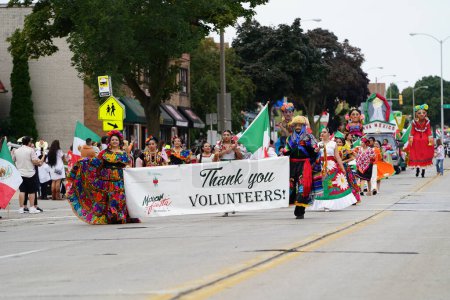 Photo for Milwaukee, Wisconsin USA - September 16th, 2023: Latino American families gathered along the streets to watch and spectate the Mexican Independence Day Parade. - Royalty Free Image