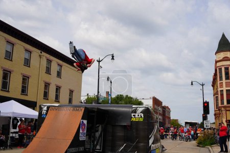 Foto de Racine, Wisconsin, EE.UU. - 16 de septiembre de 2023: Bicicletas dobles en bicicletas BMX haciendo acrobacias en rampas de media tubería para una multitud de personas en las calles de Racine, Wisconsin - Imagen libre de derechos