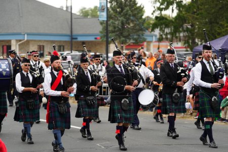 Photo for La Crosse, Wisconsin USA - October 5th, 2022: La Crosse bagpipes and drums Scottish band marched in Oktoberfest parade. - Royalty Free Image