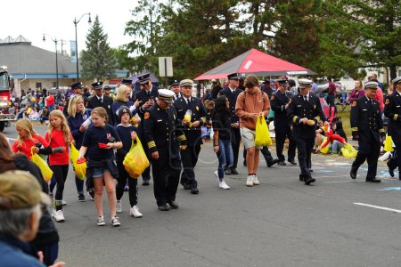Photo for La Crosse, Wisconsin USA - October 1st, 2022: La Crosse area professional Firefighters walked in 2022 Oktoberfest parade. - Royalty Free Image