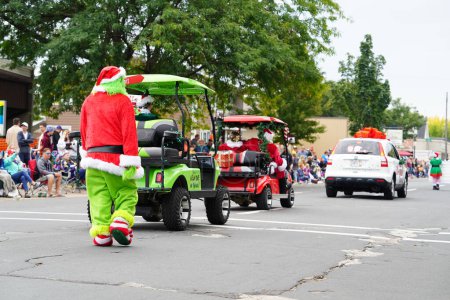 Photo for La Crosse, Wisconsin USA - October 1st, 2022: A Man dressed up in the Grinch Christmas costume and interacted with spectators at Oktoberfest parade 2022. - Royalty Free Image