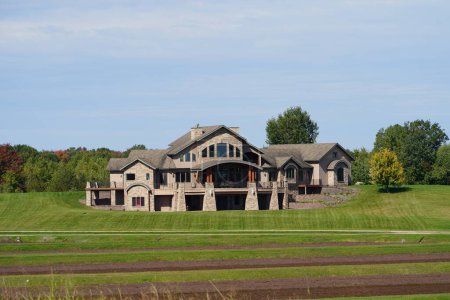 Photo for Tomah, Wisconsin USA - October 1st, 2022: Extraordinary luxury stone mansion sits on countryside. - Royalty Free Image